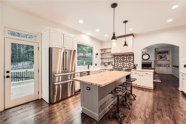 162 Taylor Ridge Way, Milton, GA 30004 - kitchen with stainless steel appliances, butcher block counters, arched walkways, a breakfast bar, and white cabinets