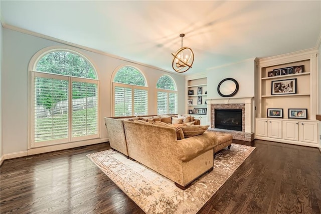 162 Taylor Ridge Way, Milton, GA 30004 - living room featuring crown molding, a chandelier, plenty of natural light, built in shelves, and a brick fireplace