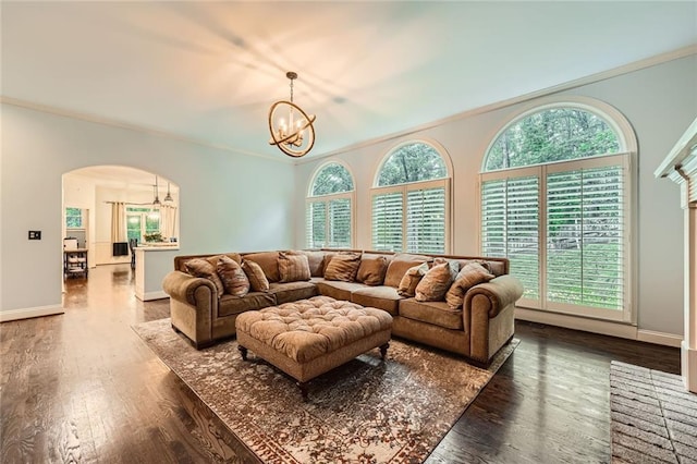 162 Taylor Ridge Way, Milton, GA 30004 - living area with a chandelier, dark wood-style flooring, arched walkways, healthy amount of natural light, and crown molding