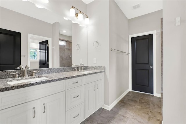 bathroom featuring vanity and a shower