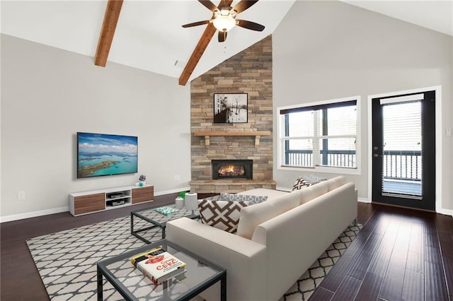 living room featuring dark hardwood / wood-style flooring, a fireplace, high vaulted ceiling, and ceiling fan