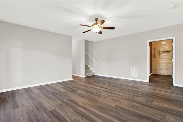 spare room featuring dark hardwood / wood-style floors and ceiling fan