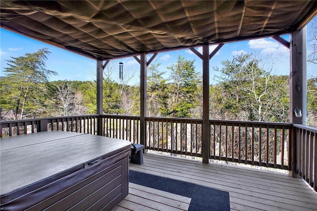 wooden terrace featuring a hot tub