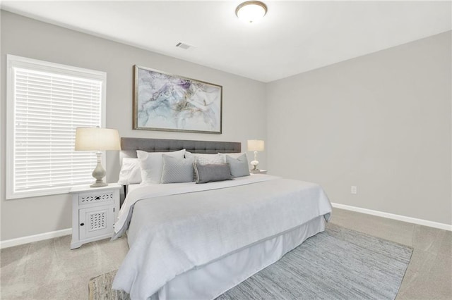 bedroom featuring light colored carpet