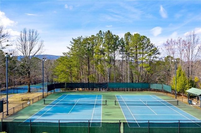 view of tennis court featuring a mountain view