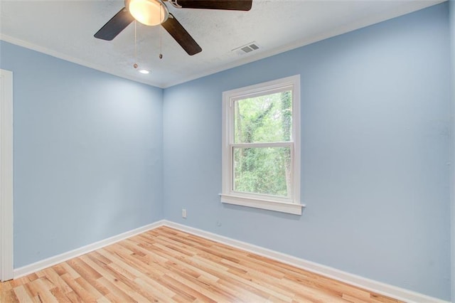 unfurnished room with crown molding, ceiling fan, and light hardwood / wood-style floors