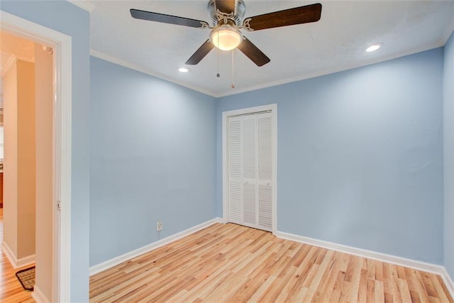 unfurnished bedroom with ceiling fan, a closet, ornamental molding, and light hardwood / wood-style flooring