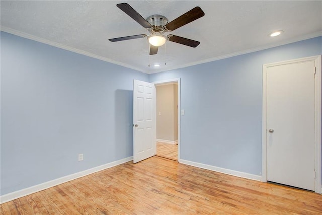 spare room featuring crown molding, ceiling fan, and light hardwood / wood-style floors