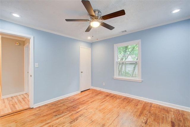 unfurnished room featuring ornamental molding, ceiling fan, and light hardwood / wood-style flooring