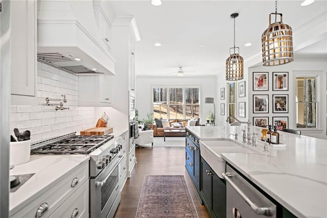 124 Long Shadows Dr, Alpharetta, GA 30004 - kitchen with appliances with stainless steel finishes, custom range hood, white cabinets, open floor plan, and a ceiling fan