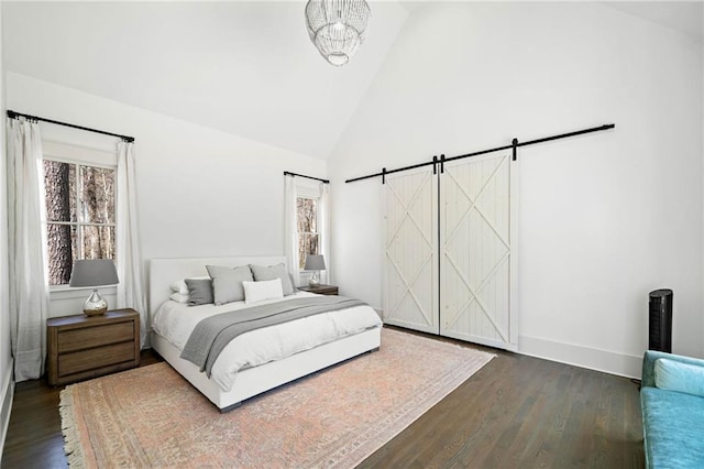 124 Long Shadows Dr, Alpharetta, GA 30004 - bedroom featuring a barn door, dark wood finished floors, and high vaulted ceiling
