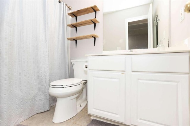 full bathroom with tile patterned floors, toilet, vanity, and curtained shower