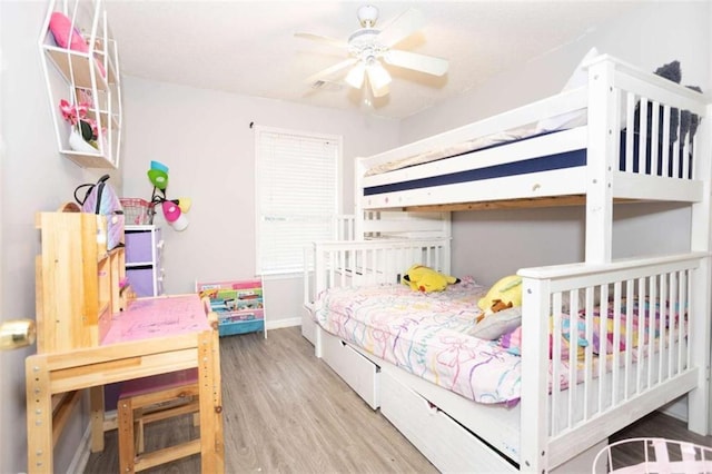 bedroom with wood finished floors and baseboards