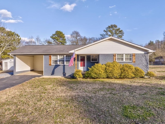 ranch-style home with a front lawn and a carport