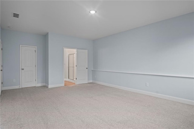 unfurnished bedroom featuring visible vents, baseboards, and light colored carpet
