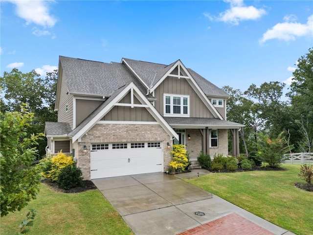 craftsman inspired home featuring a front yard, fence, roof with shingles, concrete driveway, and board and batten siding