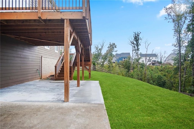 view of yard with stairs, a deck, and a patio area