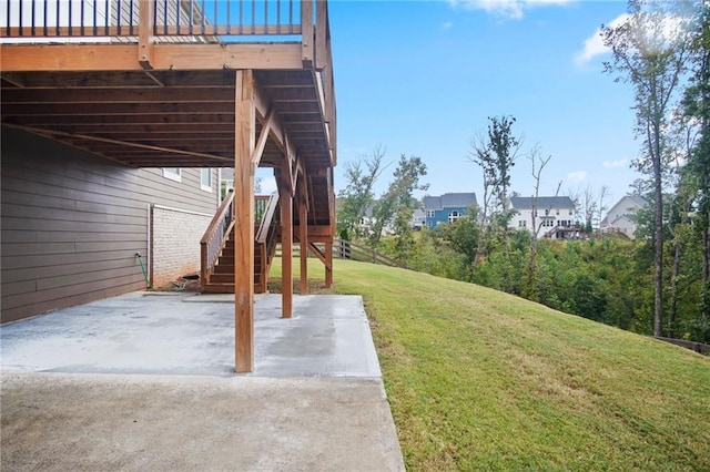 view of yard with a patio area, stairway, and a wooden deck