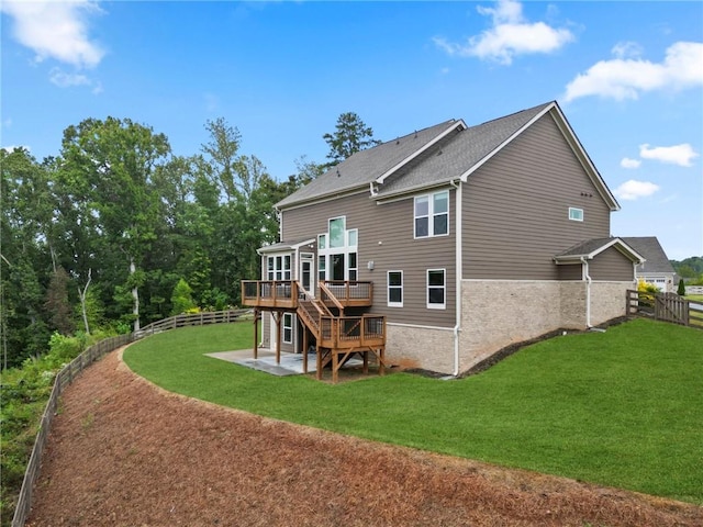 rear view of house featuring stairway, a wooden deck, a fenced backyard, a yard, and a patio area