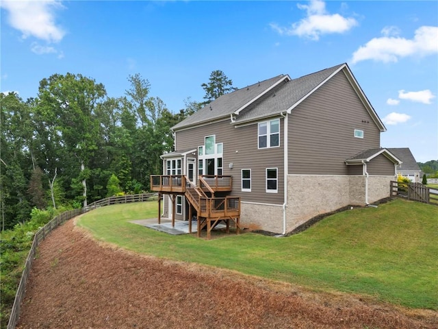 rear view of property featuring a wooden deck, a yard, a fenced backyard, stairs, and a patio area