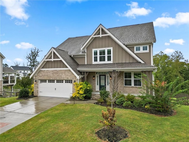 craftsman-style home with brick siding, board and batten siding, concrete driveway, a front yard, and a garage