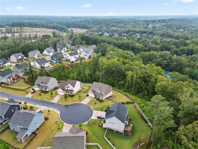 birds eye view of property with a forest view and a residential view