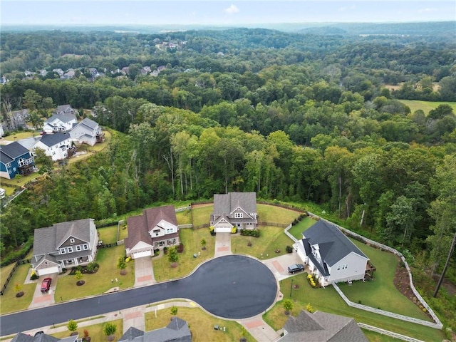 birds eye view of property with a residential view and a view of trees