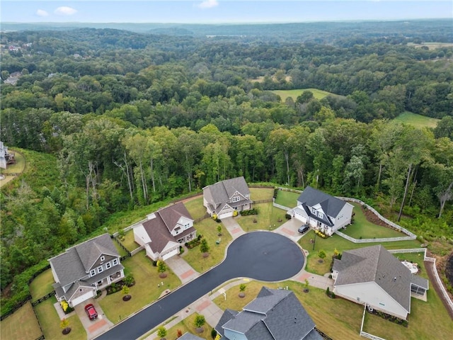 drone / aerial view with a residential view and a view of trees