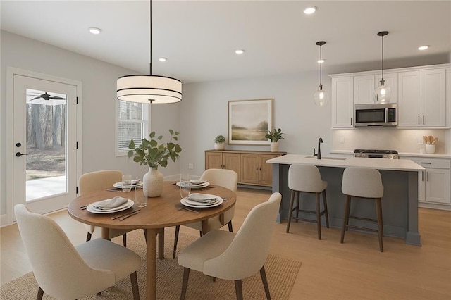 dining space featuring light wood-type flooring and recessed lighting