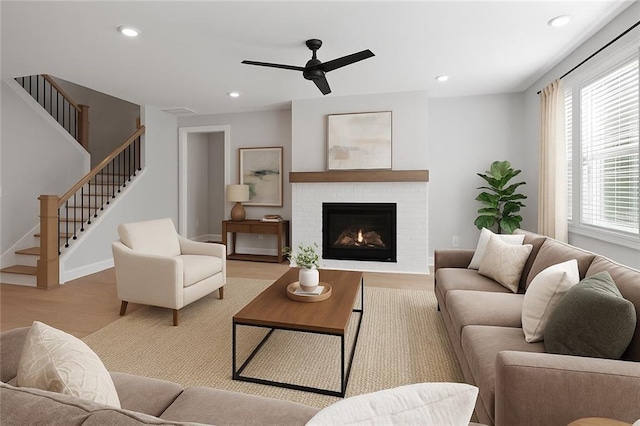 living room featuring plenty of natural light, stairs, ceiling fan, and recessed lighting