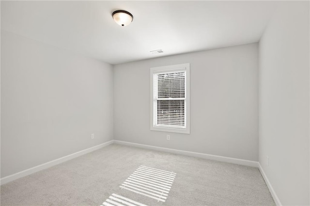 empty room with light carpet and baseboards