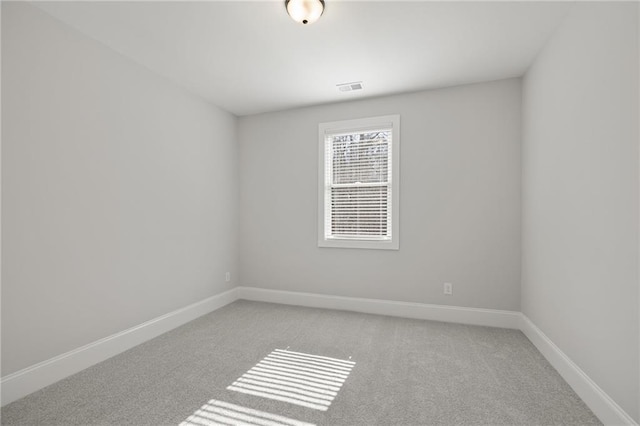 empty room with light carpet and baseboards