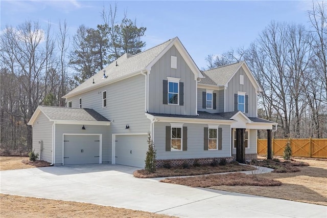 view of front of home with board and batten siding, fence, a garage, concrete driveway, and a porch