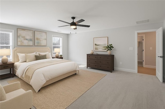 bedroom with ceiling fan, baseboards, and light carpet