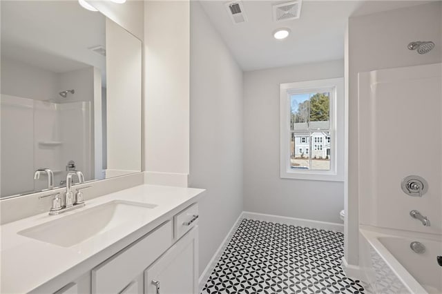 full bathroom featuring baseboards, vanity, toilet, and bathtub / shower combination