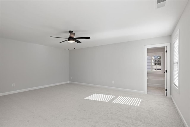 unfurnished bedroom with light colored carpet, baseboards, and ceiling fan
