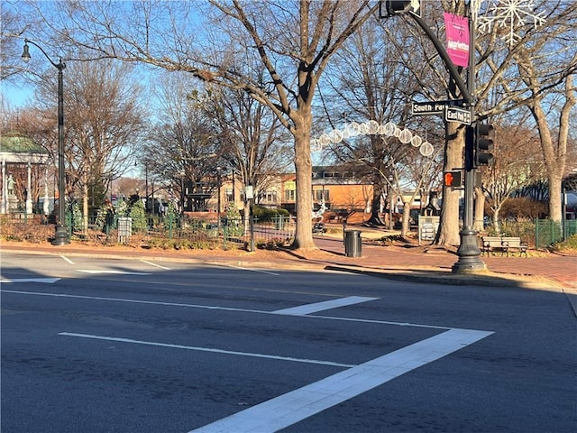 view of parking / parking lot featuring fence
