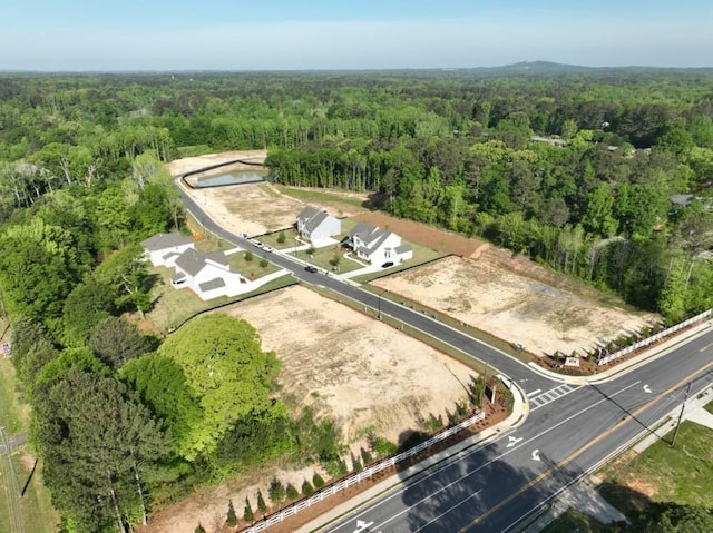 aerial overview of property's location with a heavily wooded area