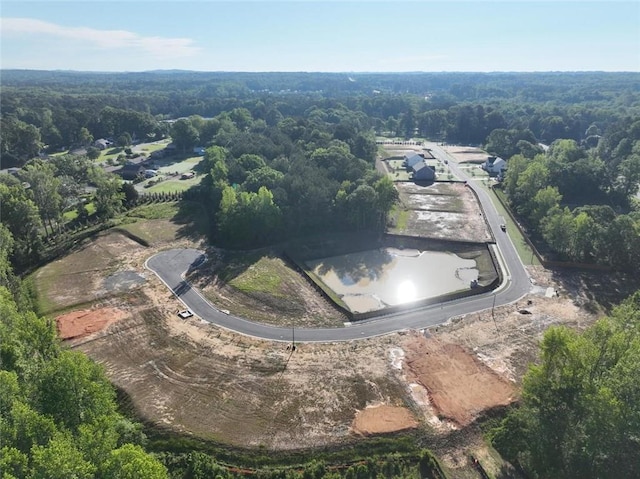 aerial view of property and surrounding area featuring a forest