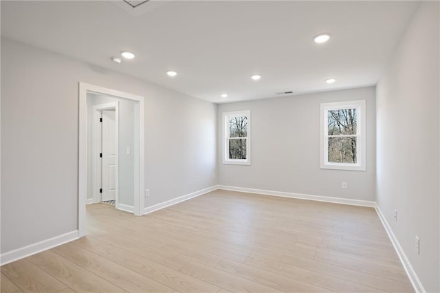 unfurnished room featuring light wood-style flooring, recessed lighting, and baseboards