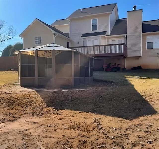 back of house with a yard and a deck