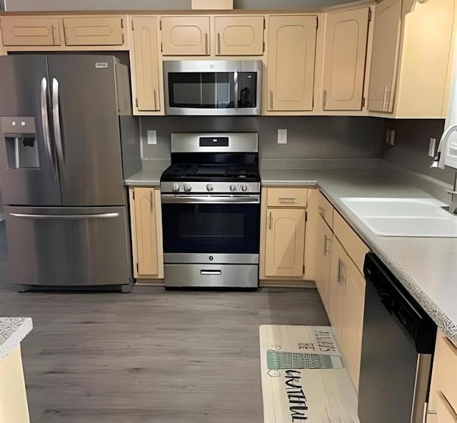 kitchen featuring sink, stainless steel appliances, and light hardwood / wood-style floors