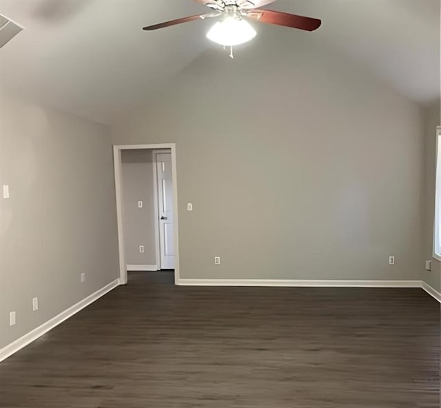 empty room with ceiling fan, dark hardwood / wood-style flooring, and lofted ceiling