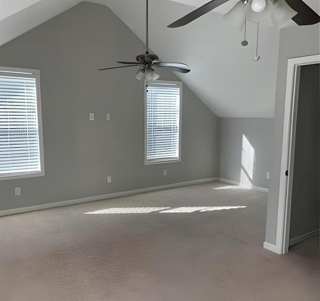 additional living space featuring light carpet, plenty of natural light, ceiling fan, and lofted ceiling