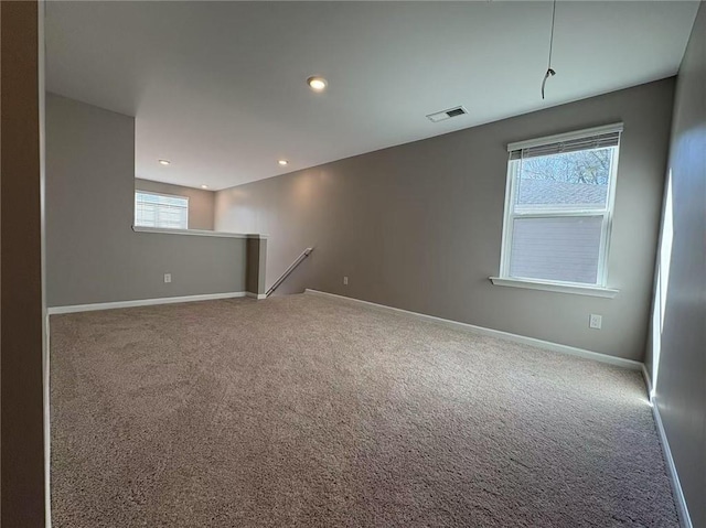 unfurnished room featuring carpet floors, recessed lighting, visible vents, and baseboards