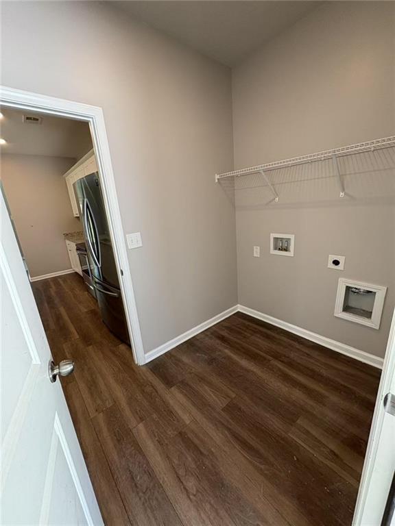 laundry room featuring hookup for a washing machine, hookup for an electric dryer, laundry area, dark wood-style flooring, and baseboards