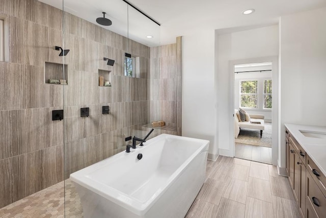 6930 Pond View Dr, Cumming, GA 30028 - bathroom featuring a walk in shower, a freestanding bath, connected bathroom, recessed lighting, and vanity