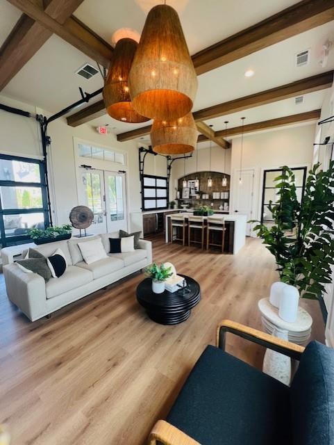 6930 Pond View Dr, Cumming, GA 30028 - living area with wood finished floors, beam ceiling, and french doors
