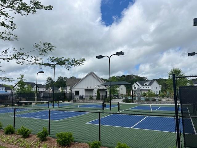 6930 Pond View Dr, Cumming, GA 30028 - view of tennis court featuring fence, a residential view, and community basketball court