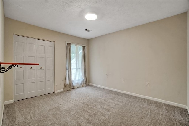 unfurnished bedroom with carpet, visible vents, and baseboards
